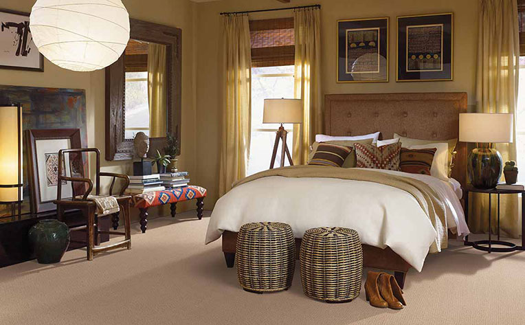 Bedroom with bed and decor designed to give the room a rustic cabin feel.